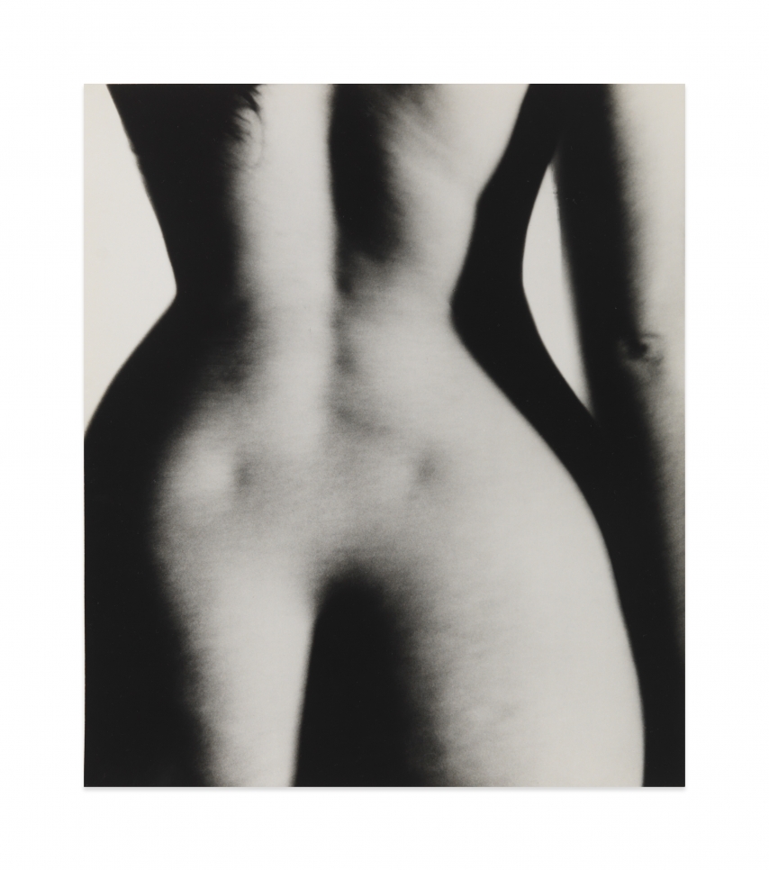 Black and white photograph by Bill Brandt showing a nude midriff from behind